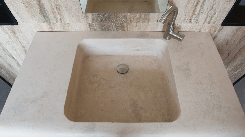 Designer travertine washbasin "Cave"