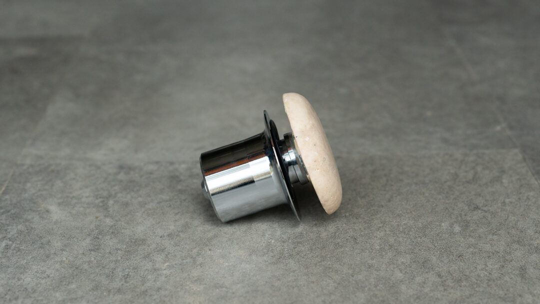 Light travertine drain stopper side