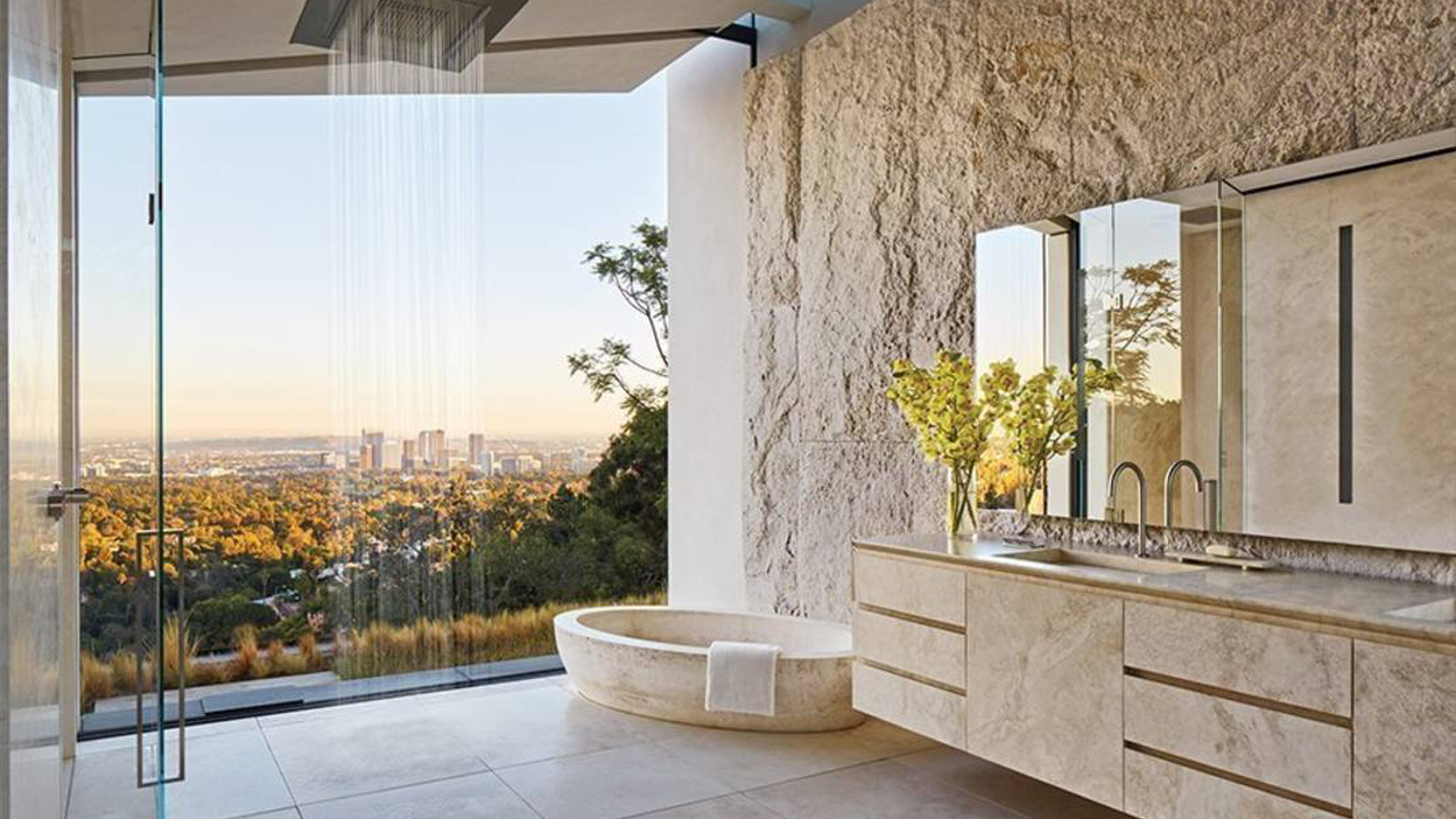 Un bagno della villa a Bel Air di Michael Bay, con vasca in travertino Un bagno della villa a Bel Air di Michael Bay, con vasca in travertino
